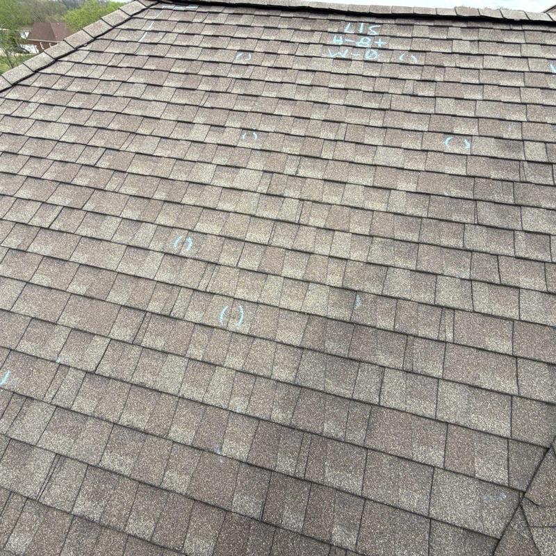 Asphalt shingle roof with hail damage marks