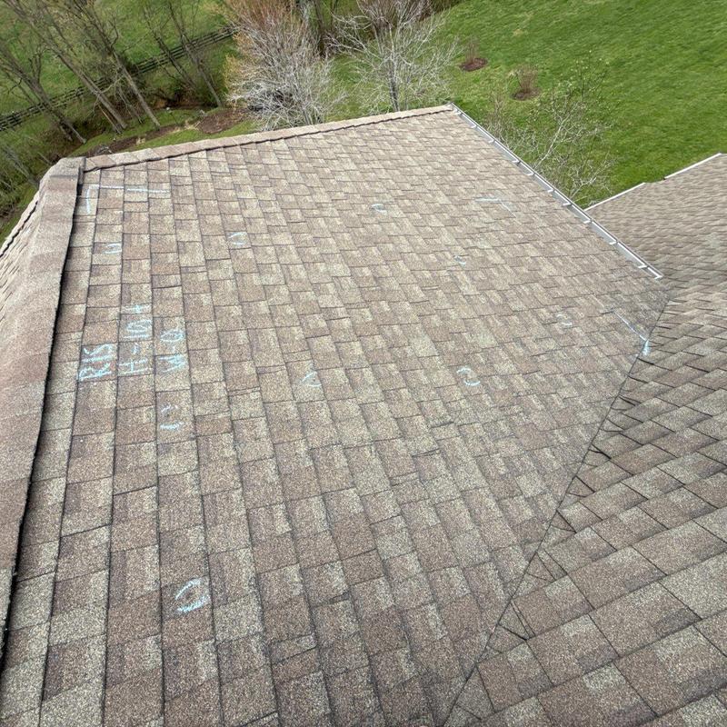 Asphalt shingle roof with hail damage marks overview