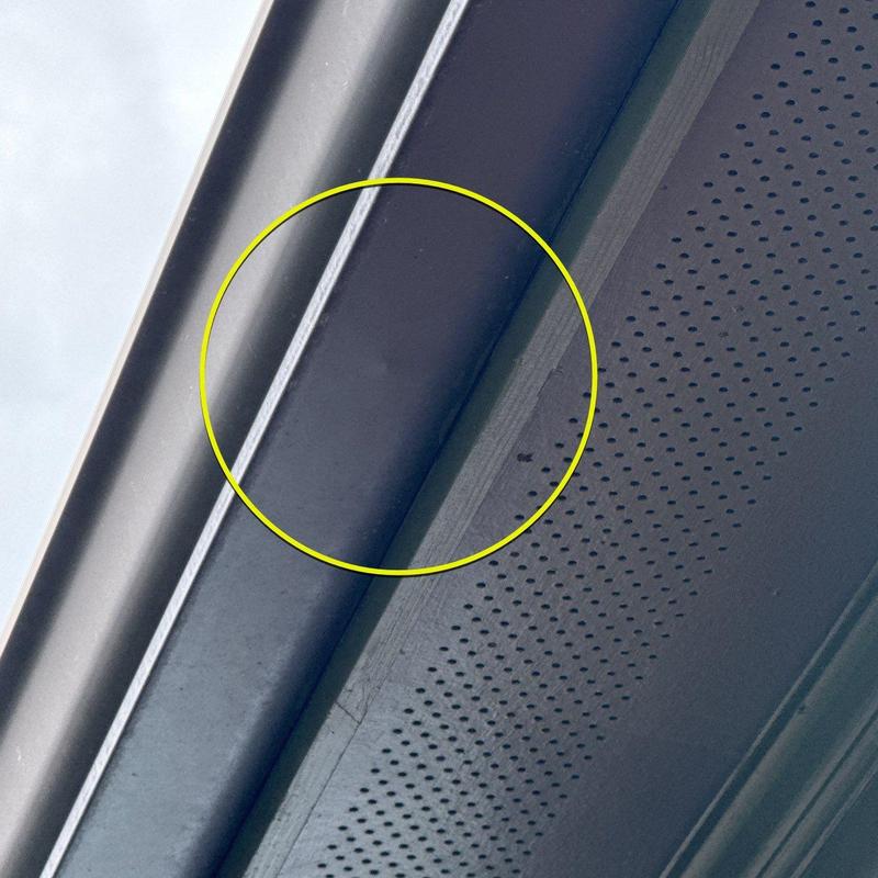 Gutter section with hail damage circled in yellow