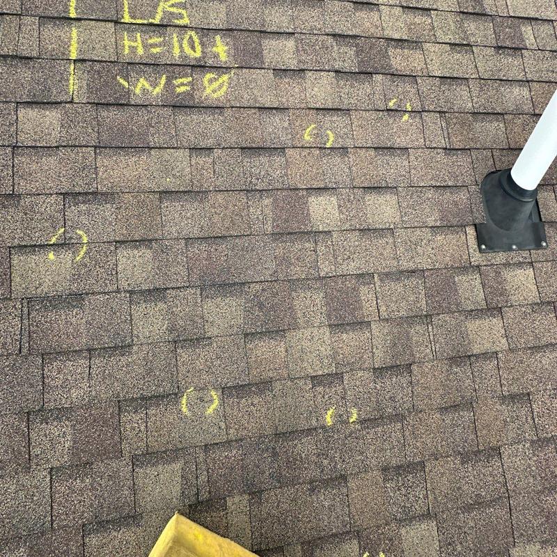 Asphalt shingle roof with hail damage markings