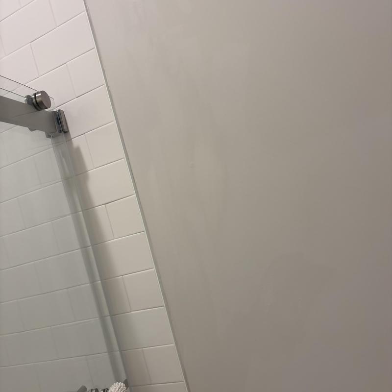 Shower glass door with metal hinge and tiled wall