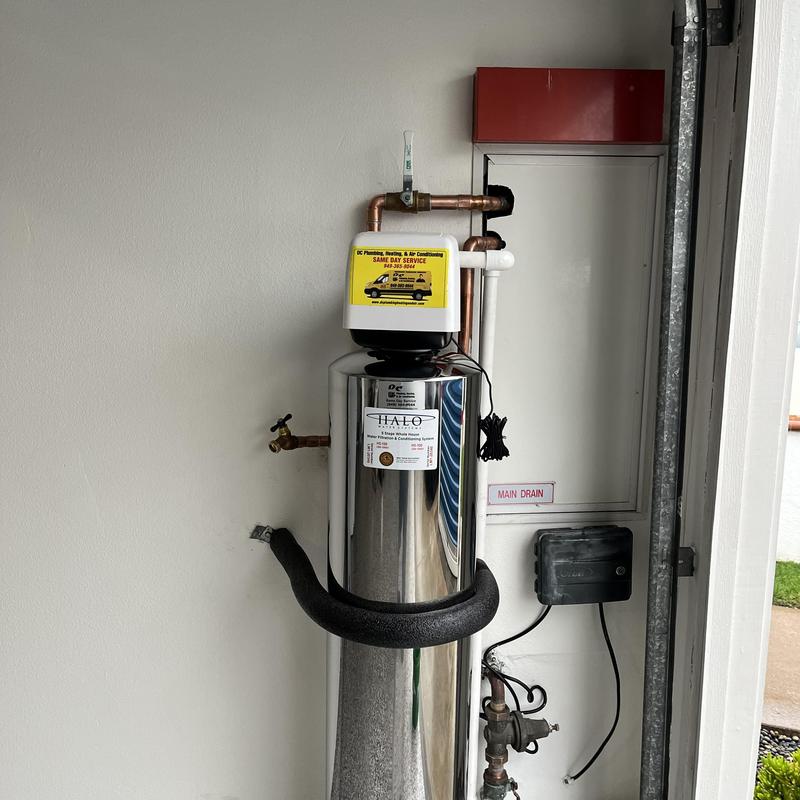 Water softener system with plumbing connections installed
