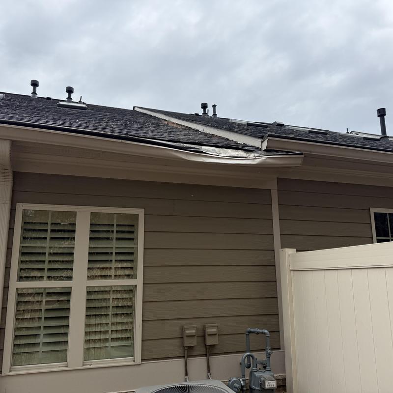 6-inch damaged gutter and gutter guard on roof edge
