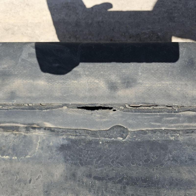 EPDM roof with puncture and seam separation damage EPDM roof with puncture and seam separation damage