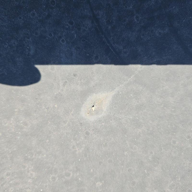 EPDM roof puncture on flat roof surface EPDM roof puncture on flat roof surface