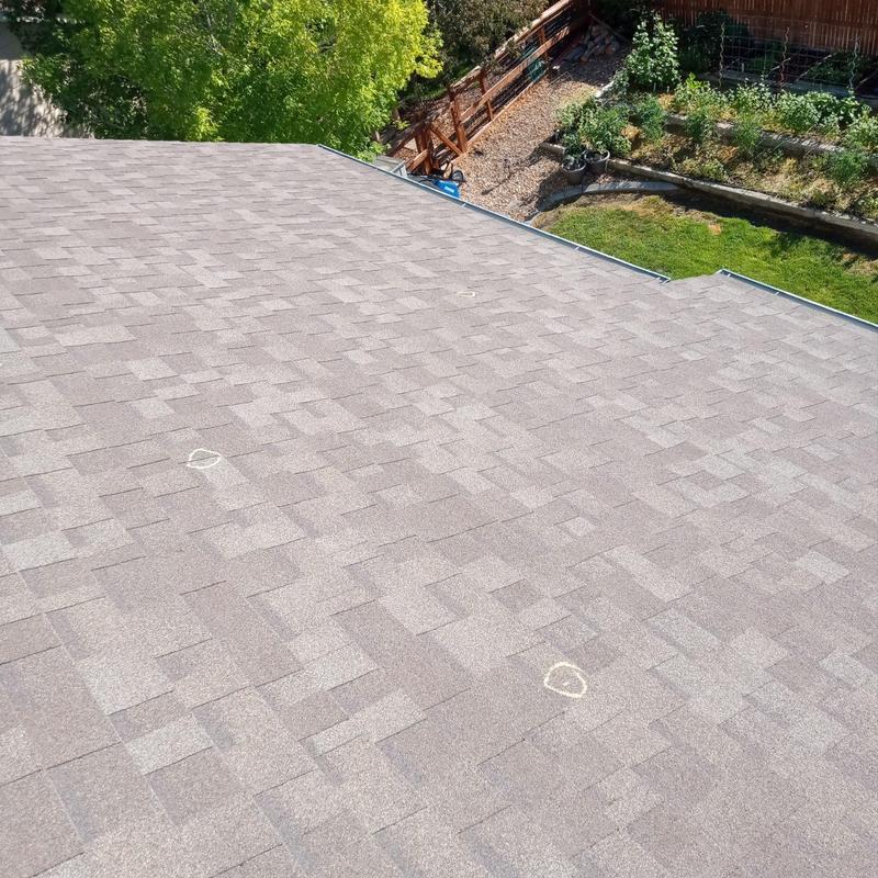 Asphalt roof shingles with minor hail damage markings Asphalt roof shingles with minor hail damage markings