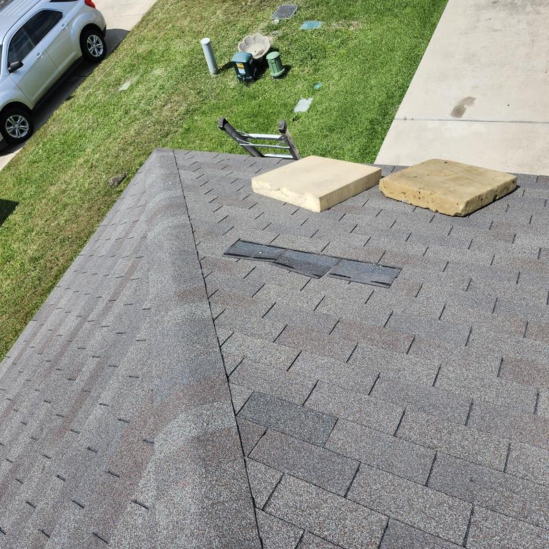 Roof shingles with wind damage and replacement pads