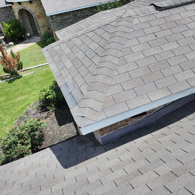 Weather Gray GAF shingles with wind damage on roof