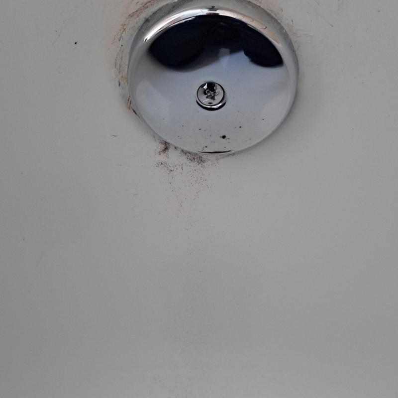Tub overflow faceplate with rust and grime buildup