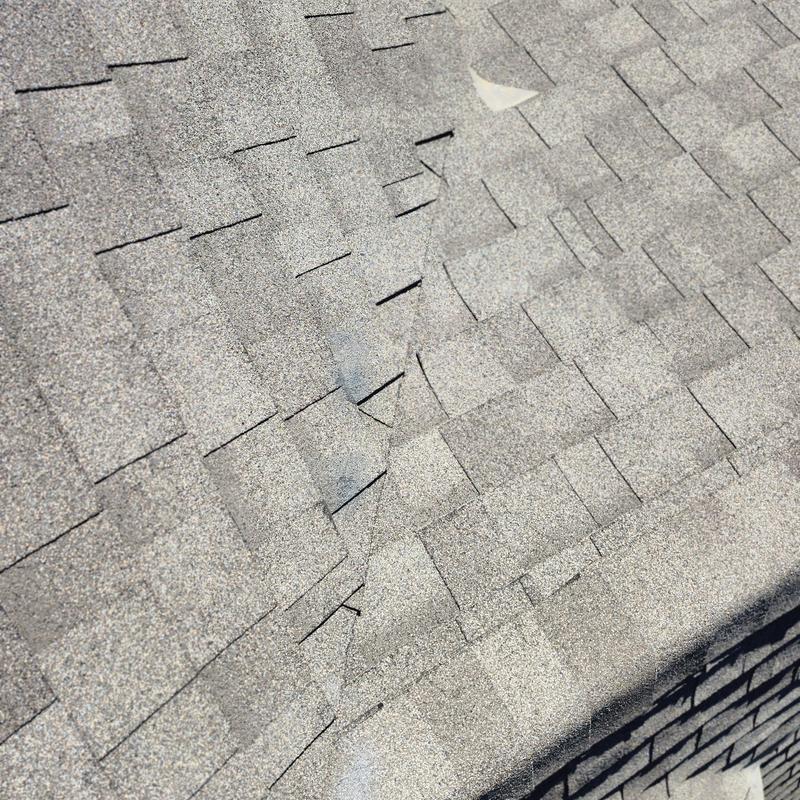 Asphalt roof shingles with caulked fasteners and paint
