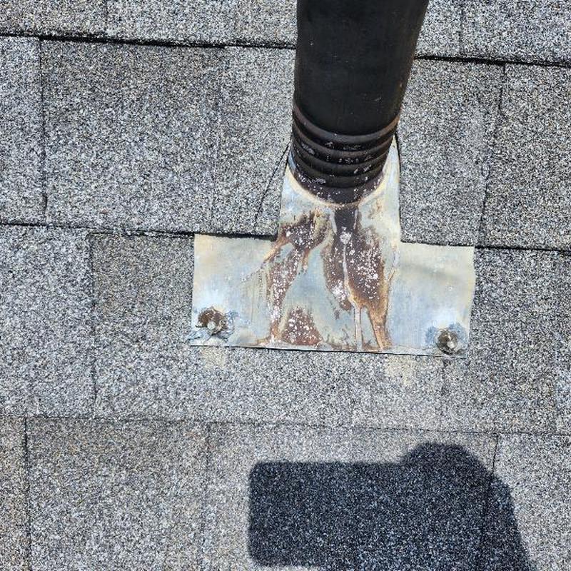 Roof pipe flashing with rusted exposed fasteners