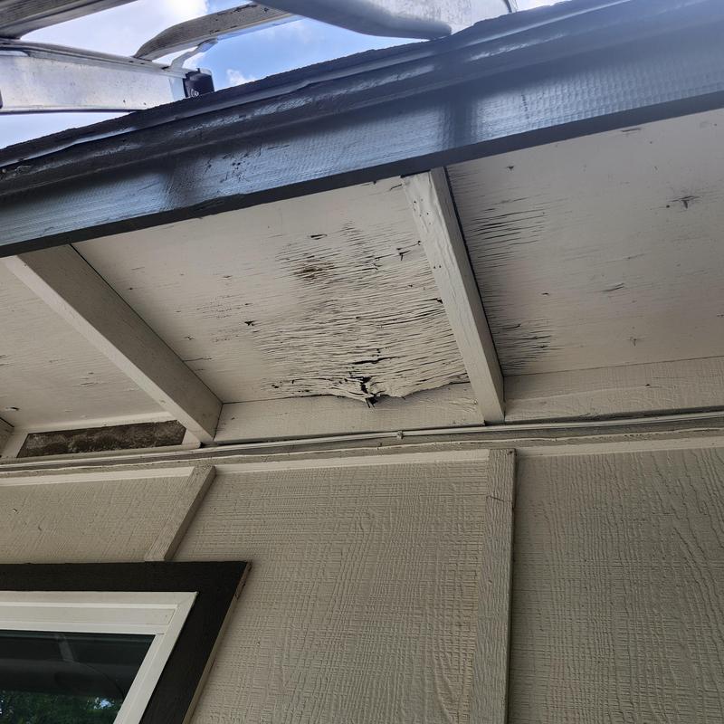Soffit with water damage and rotted wood panels