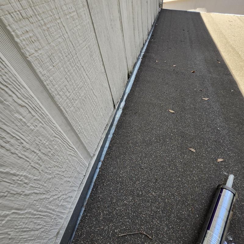 Drip edge flashing and roll roofing gap sealed