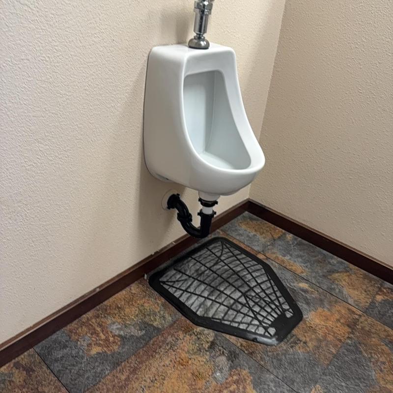 Urinal with new flange and mounting hardware installed