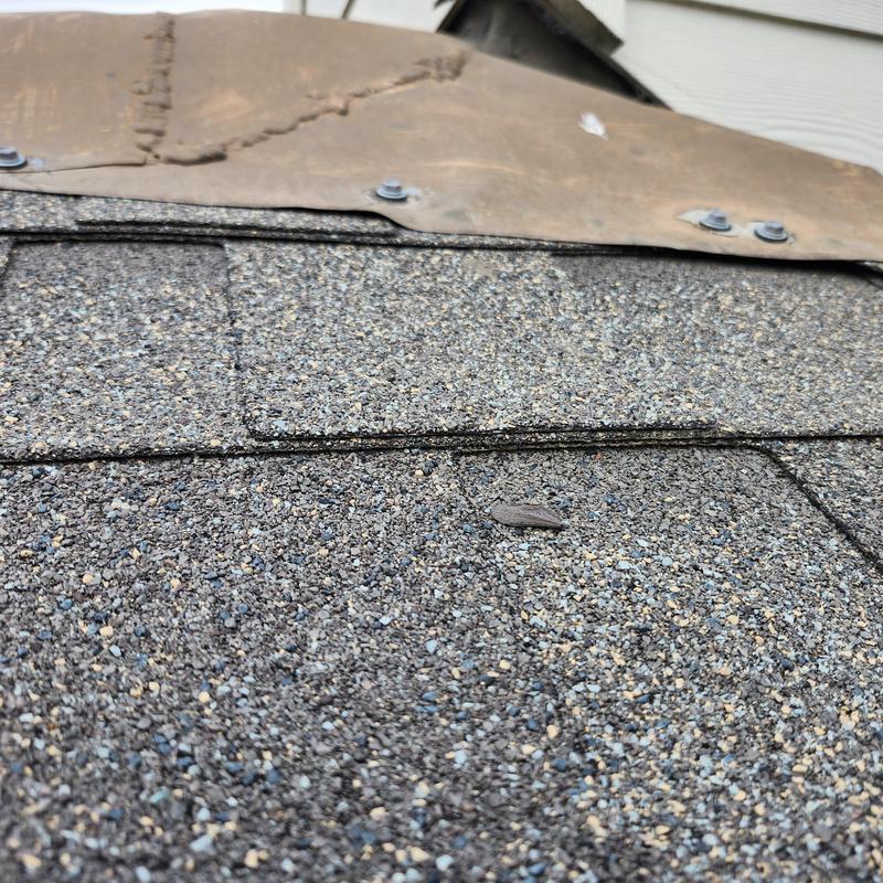 Turnback flashing and exposed ridge fasteners on roof