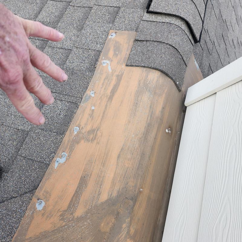 Turnback flashing with sealed exposed fasteners on roof ridge