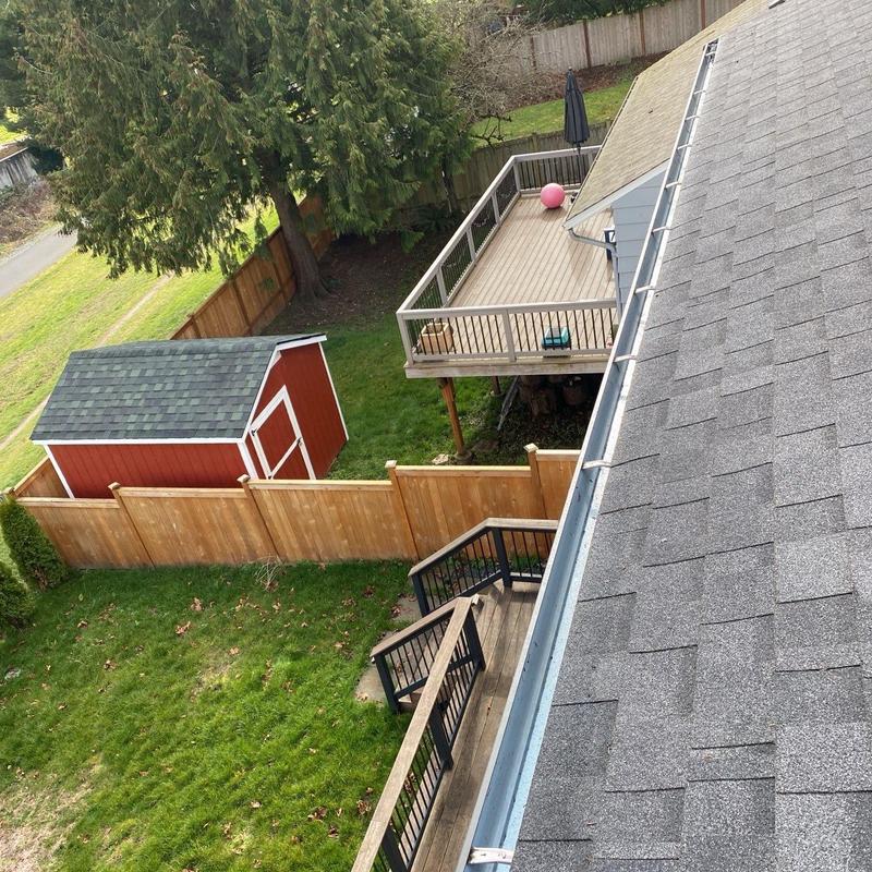 Gutter system with roof leaf blow debris removal