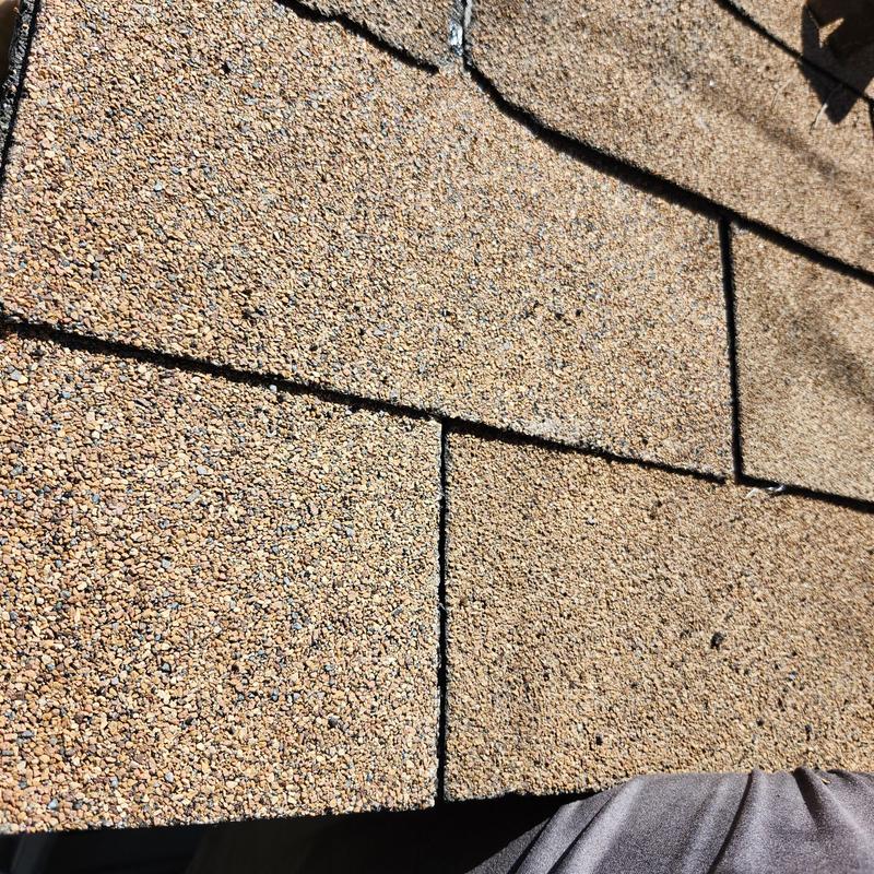 Storage shed roof shingles in golden cedar color close-up