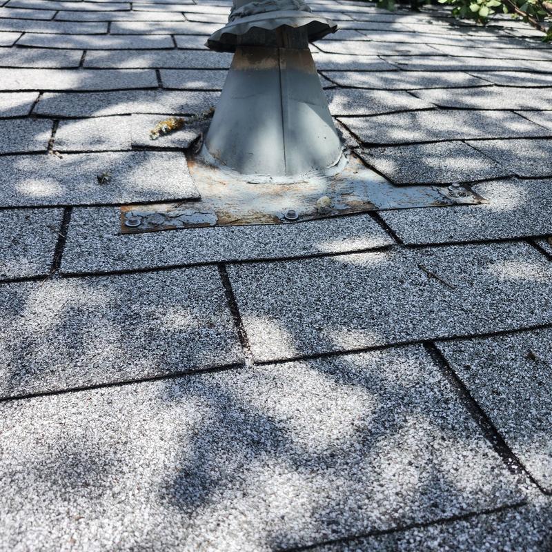 Lead plumbing boot on shingled roof with sealant
