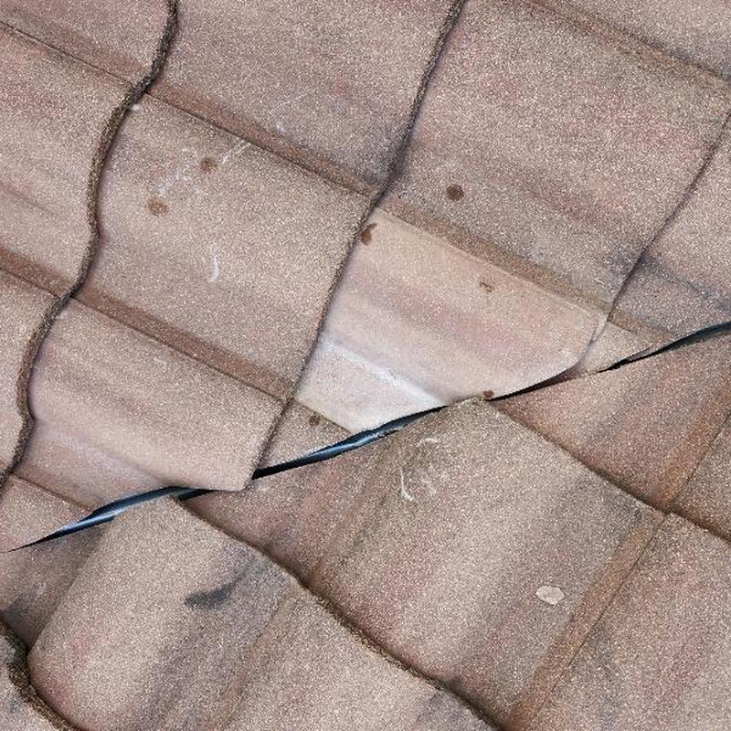 Clay barrel terracotta roof tiles with visible crack Clay barrel terracotta roof tiles with visible crack