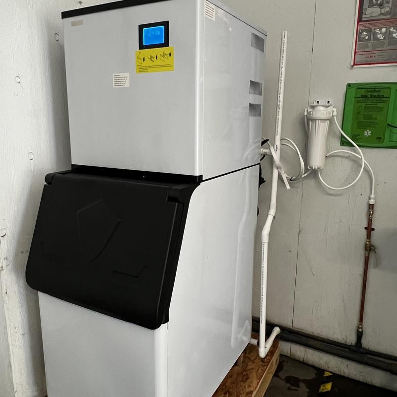 Ice machine with new water line and drain installation
