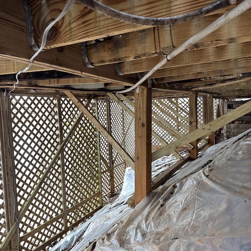 Wooden joists and posts with lattice crawl space enclosure