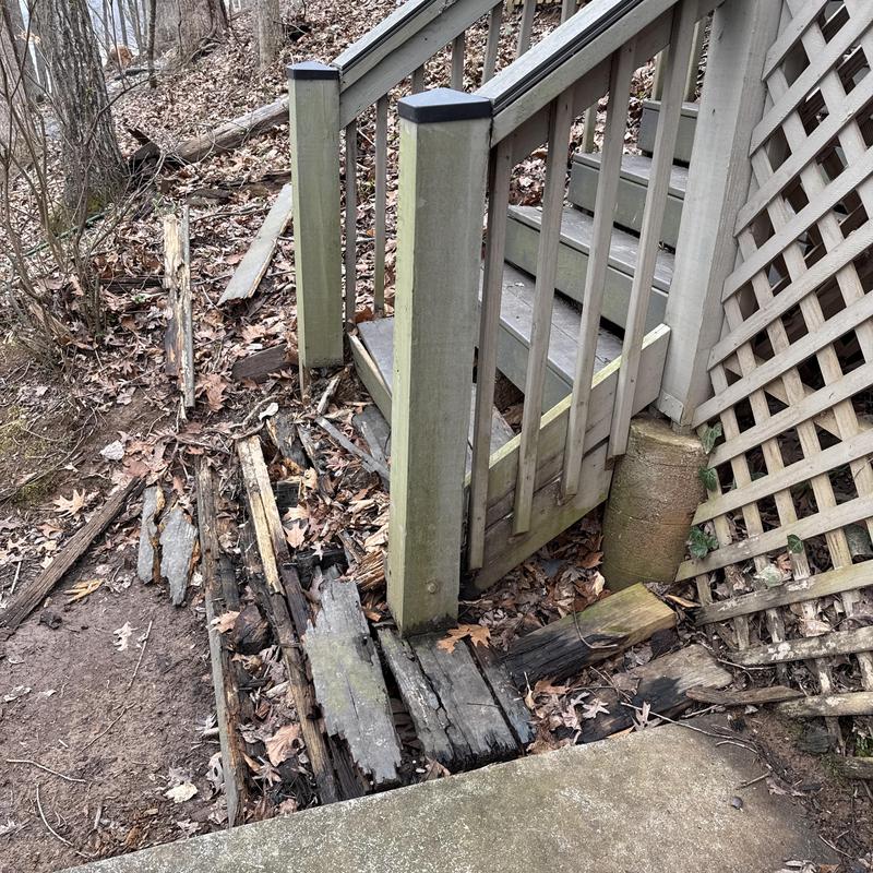 Wooden joists and staircase with severe rot damage