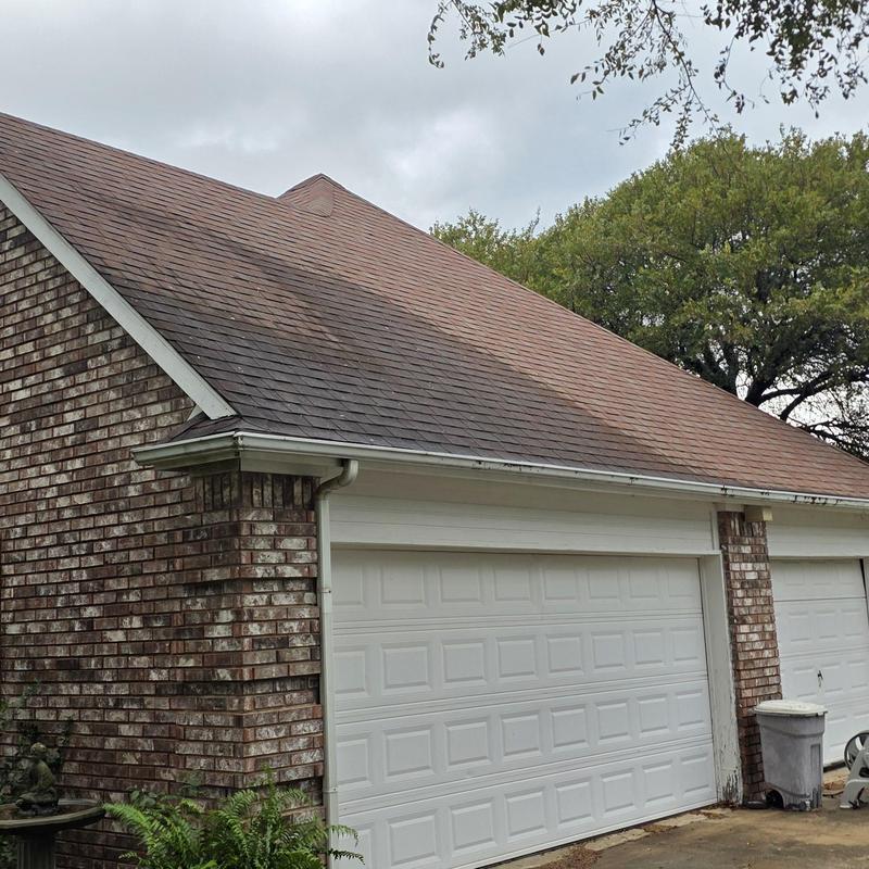 Asphalt shingle roof showing hail and wind damage