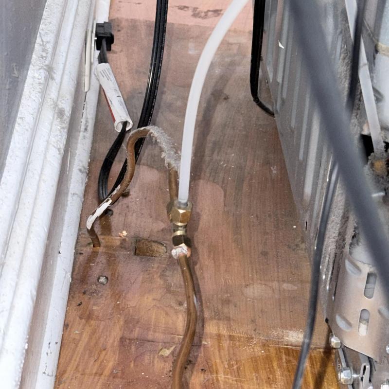 Icemaker copper line with water leak under appliance