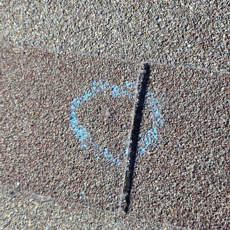 Shingle roof hail damage marked with blue chalk