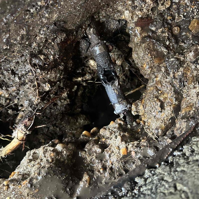 Damaged underground metal pipe in mud excavation site Damaged underground metal pipe in mud excavation site