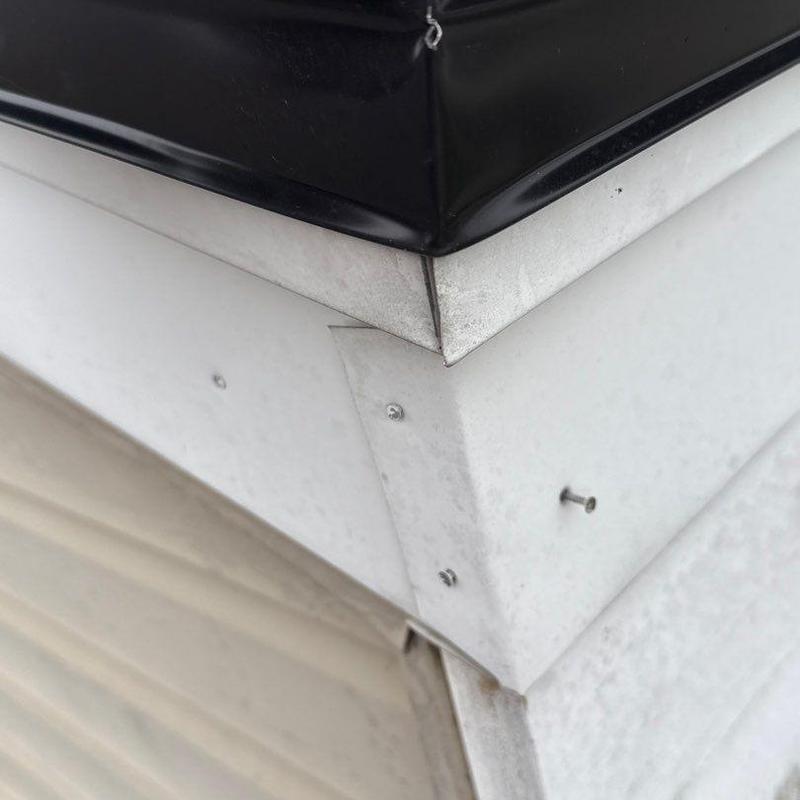 Metal roof flashing corner with loose screws