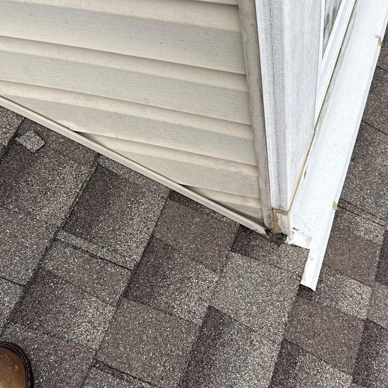 Shingle roof corner with flashing and siding detail