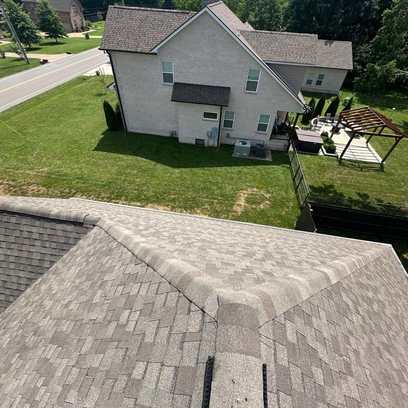 Asphalt shingle roof ridge inspection with hail damage