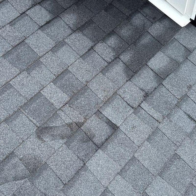 Roof shingles with visible hail damage and wear