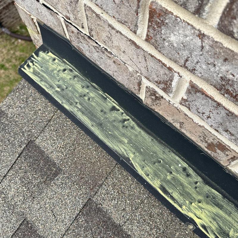Flashing sealant on roof brick chimney base
