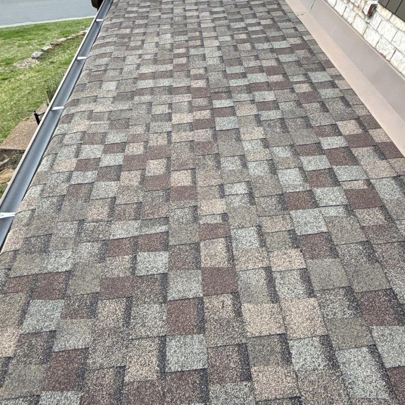 Asphalt shingle roof with hail damage and gutter system