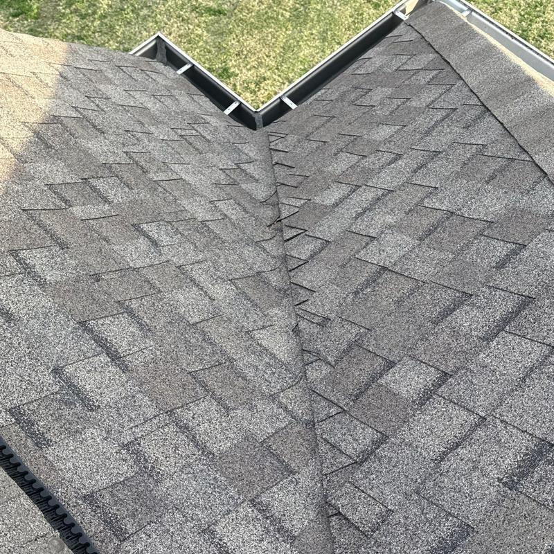 Asphalt shingle roof with valley flashing and gutter system