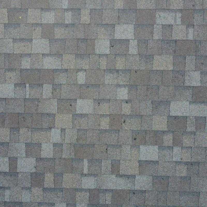 Asphalt roof shingles with hail damage marks Asphalt roof shingles with hail damage marks