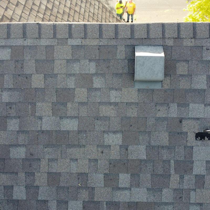 Asphalt shingle roof with hail damage and vent pipe visible Asphalt shingle roof with hail damage and vent pipe visible