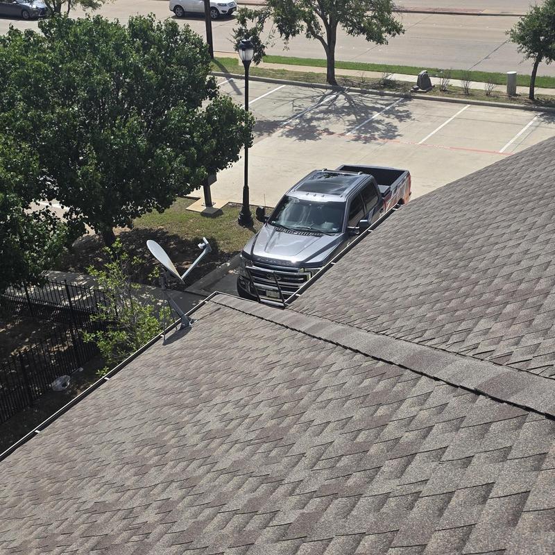 Asphalt shingle roof with wind and hail damage visible