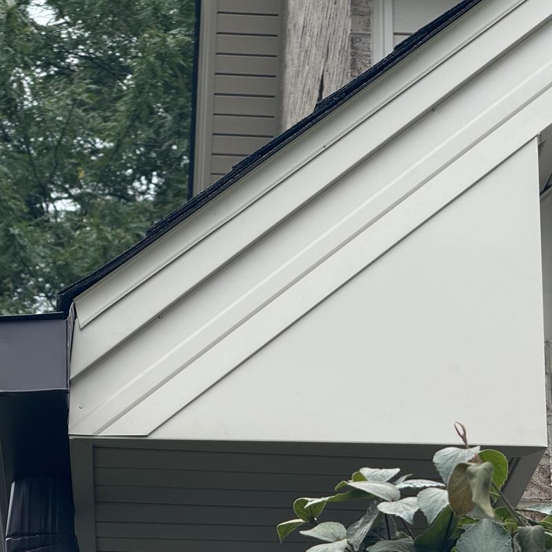 Composite insulated siding and soffit with fascia trim