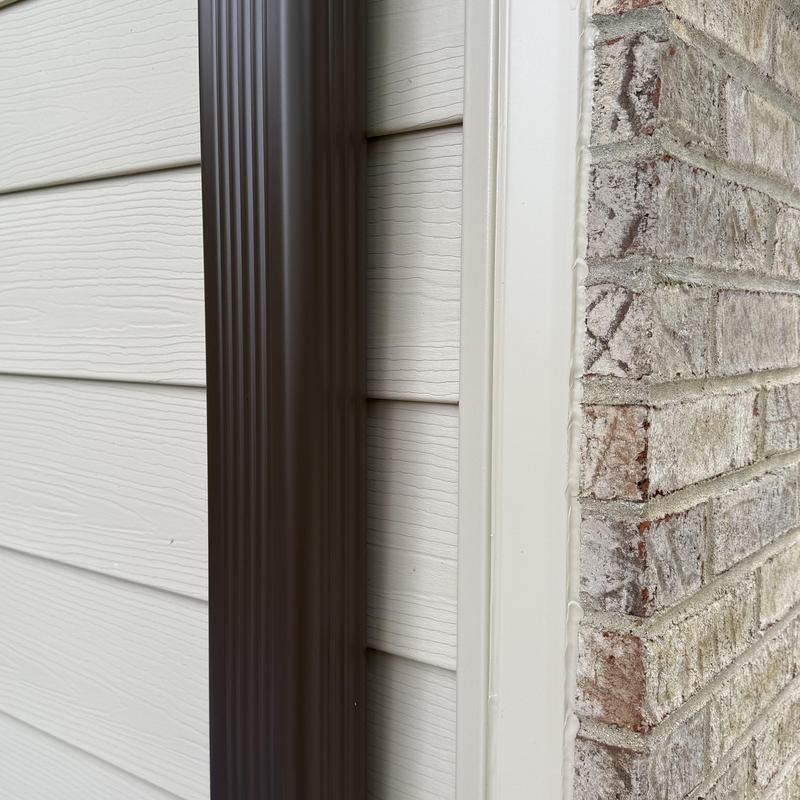 Composite insulated siding and downspout detail