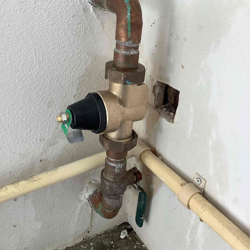 Pressure regulator valve with copper and PVC pipes