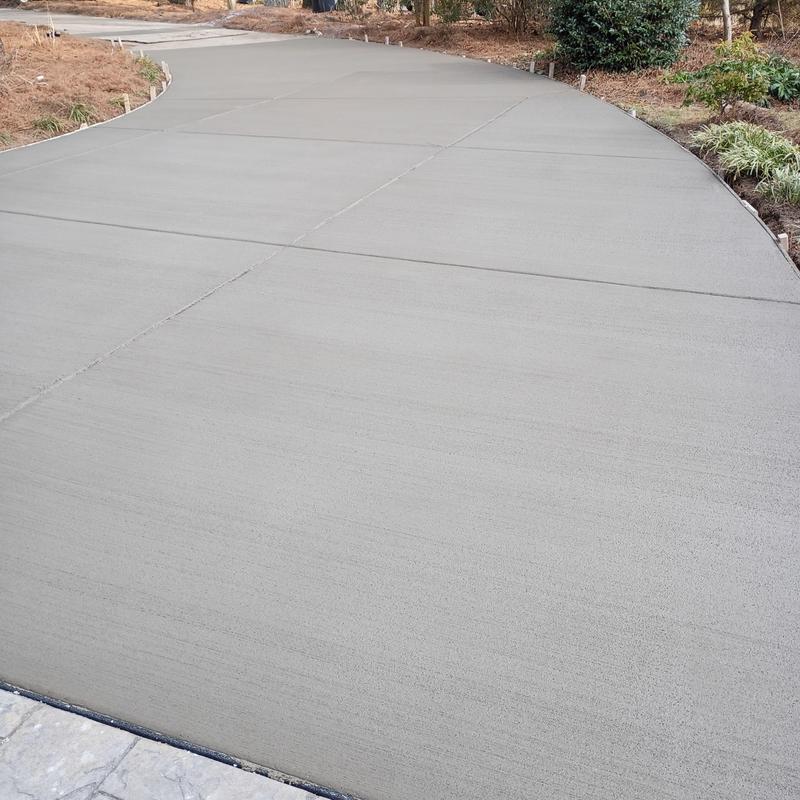 Concrete driveway with new curb installation