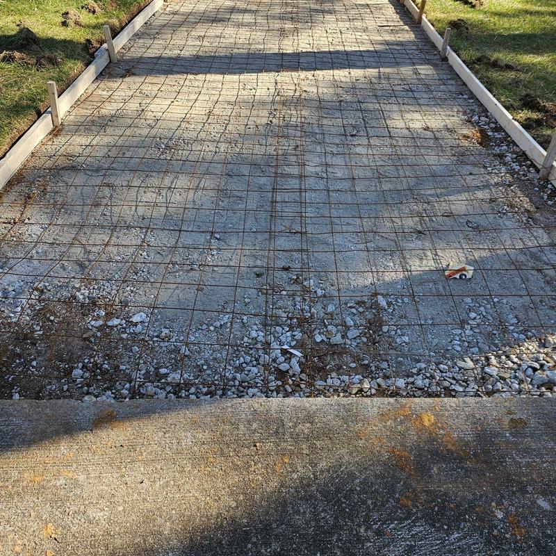 Concrete driveway preparation with wire mesh and gravel base