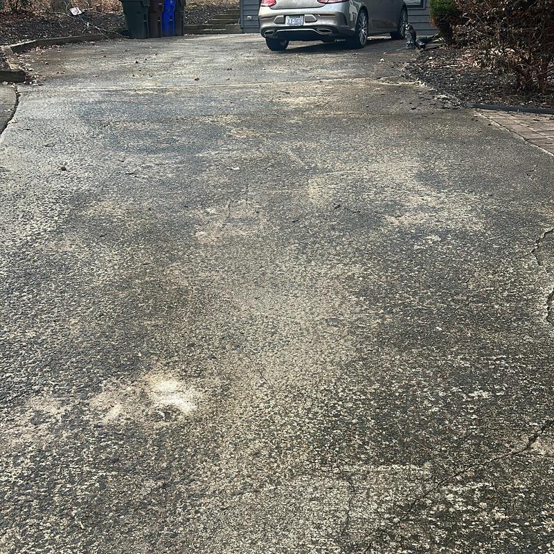 Concrete driveway with wear and cracks before replacement