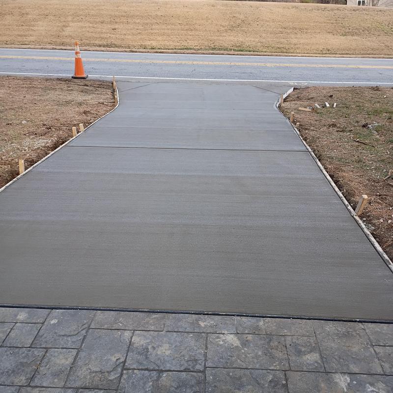 Concrete driveway with new smooth surface and edging