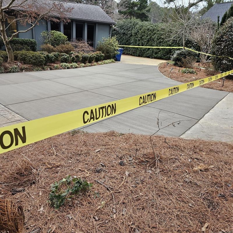 Concrete driveway fresh installation with caution tape