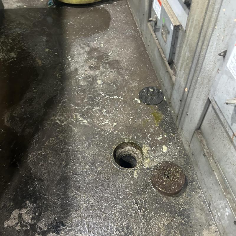 Sanitary line access hole with removed cover in basement